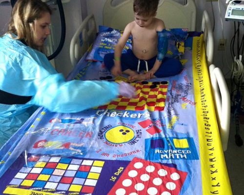 Nurse and Child playing on Therapy Sheets
